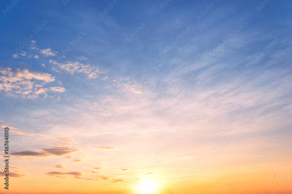 Sky background at sunset,Sky blue and orange light of the sun through the clouds in the sky ...