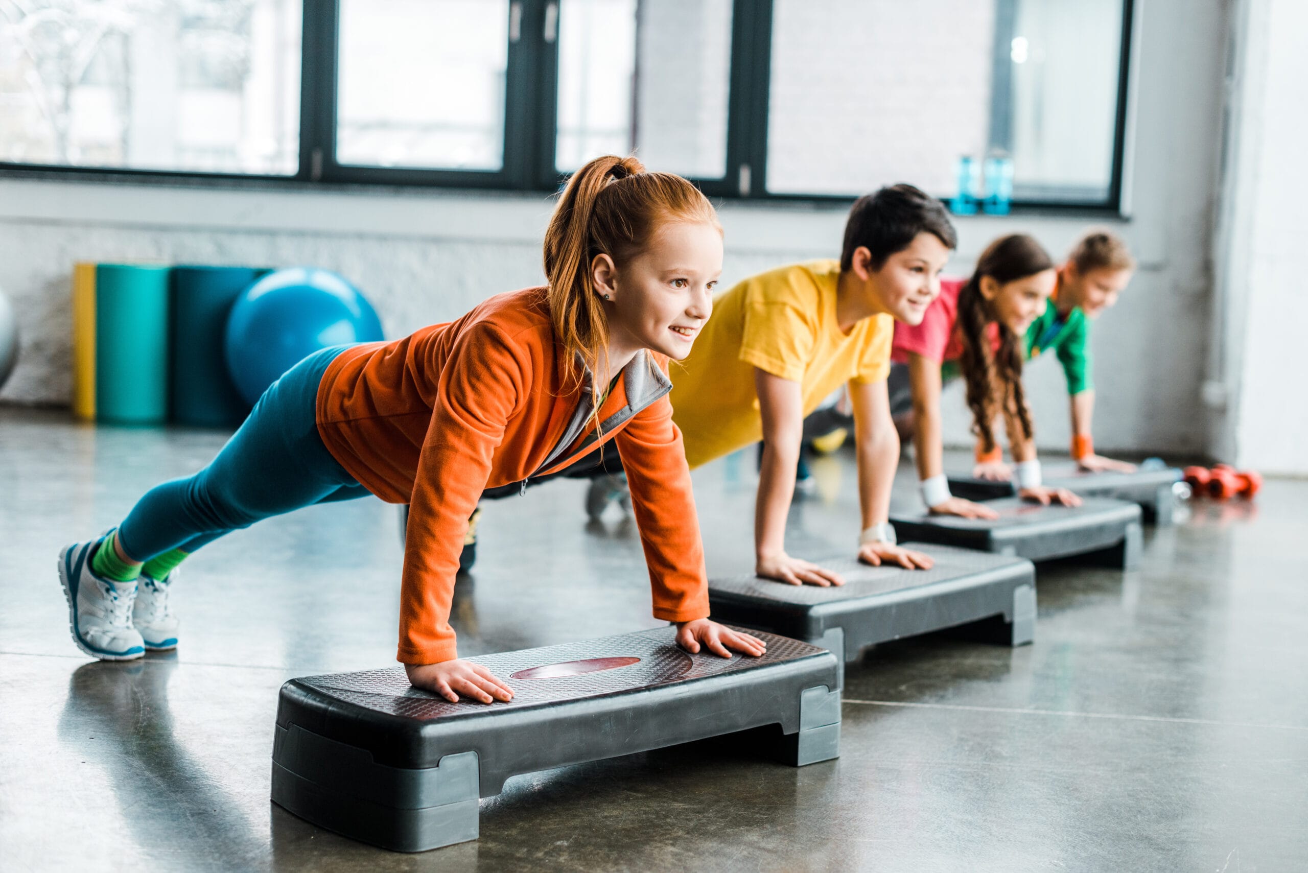 Children Doing Plank Exercise With Step Platforms - Lakeshore Sport & Fitness